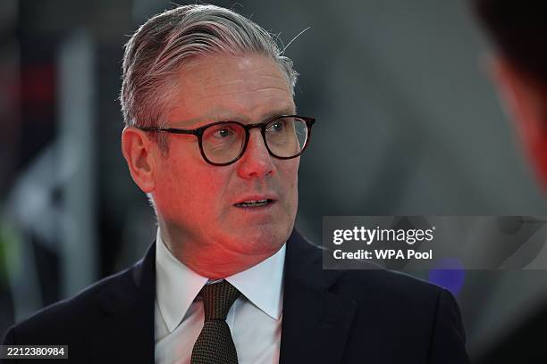 Prime Minister Keir Starmer speaks with staff members during a visit to a defence contractor on May 2, 2025 in Bedfordshire, England.