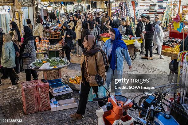 View of the outdoor market where people are walking around and shopping. Rasht is the capital of Gilan Province and the most populous city in...