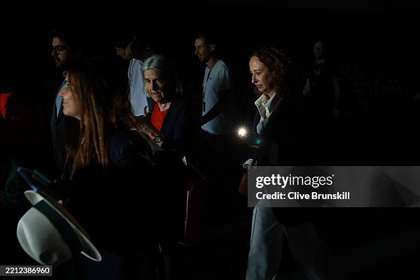 People use their phone torch to walk through the dark gangways during a general power blackout during Day Seven of the Mutua Madrid Open at La Caja...