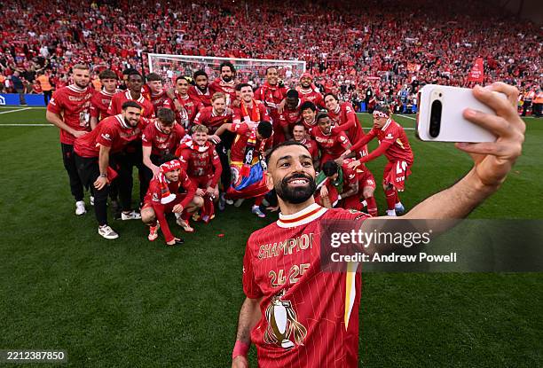 Mohamed Salah of Liverpool takes a selfie with his team mates and Liverpool fans in the Kop end celebrating after being named Premier League...