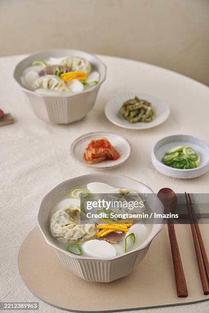 rice cake dumpling soup - korean dumpling stock pictures, royalty-free photos & images