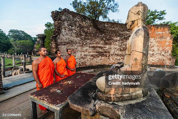 sri lankan buddhist monks walking inside an ancient temple, ceylon - sri lankan ethnicity stock pictures, royalty-free photos & images