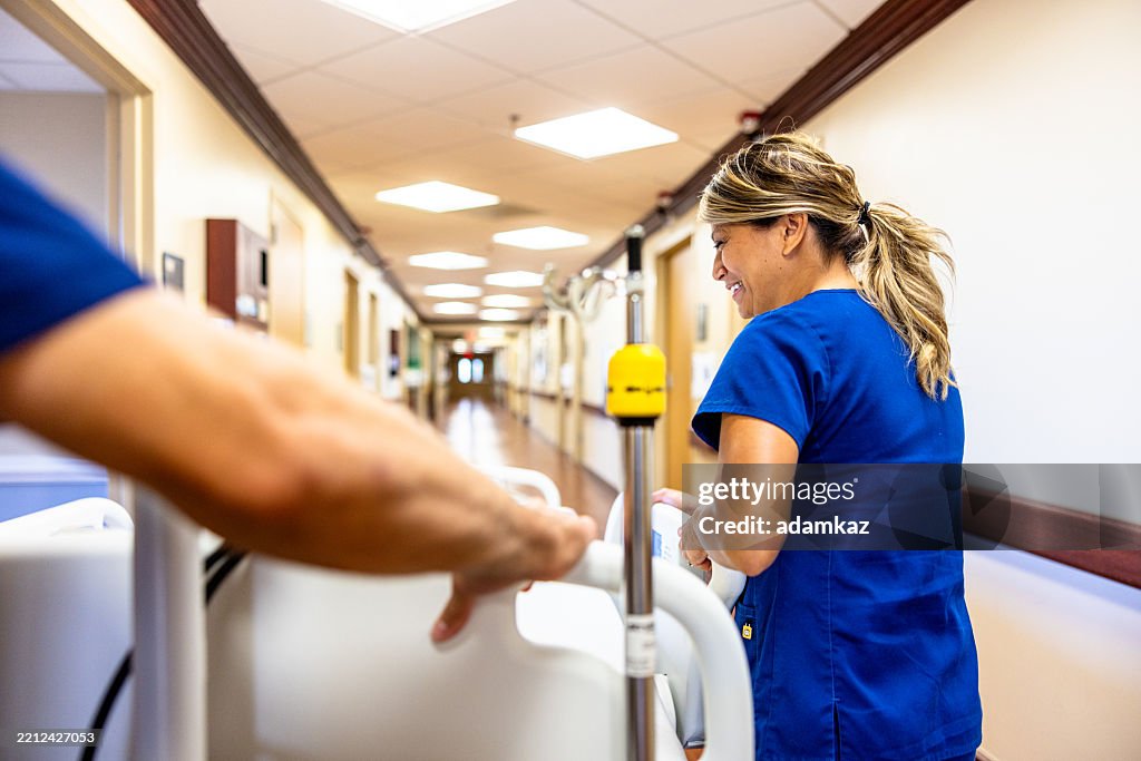 Nurses pushing a hospital bed with a patient down the hallway