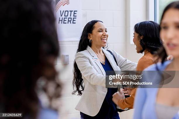 happy women embracing after voting in the usa - voting rights stock pictures, royalty-free photos & images