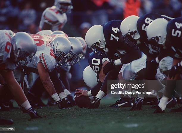 General view of the line of scrimmage as the offensive line of the Penn State Nittany Lions sets their feet in preparation to block the defensive...