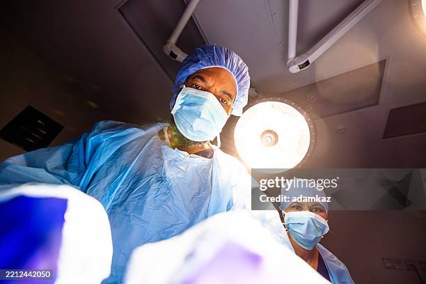 black surgeon in operating room - newborn heart surgery stock pictures, royalty-free photos & images
