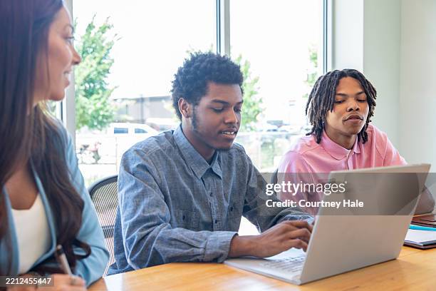 gen z businessmen working at startup company collaborate while using laptop - african american female lawyer stock pictures, royalty-free photos & images