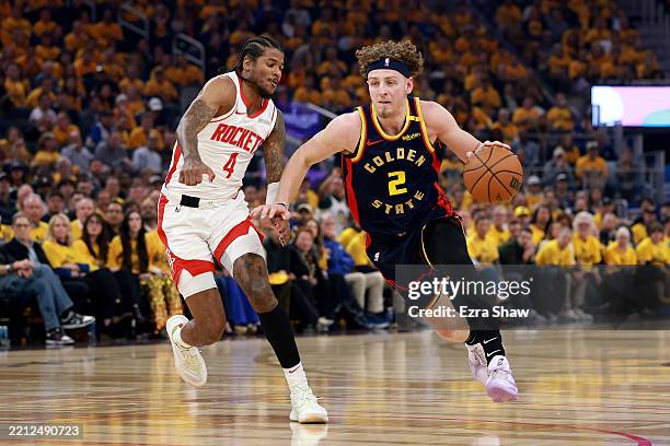 Brandin Podziemski of the Golden State Warriors drives to the basket against Jalen Green of the Houston Rockets during the first quarter in Game Four...