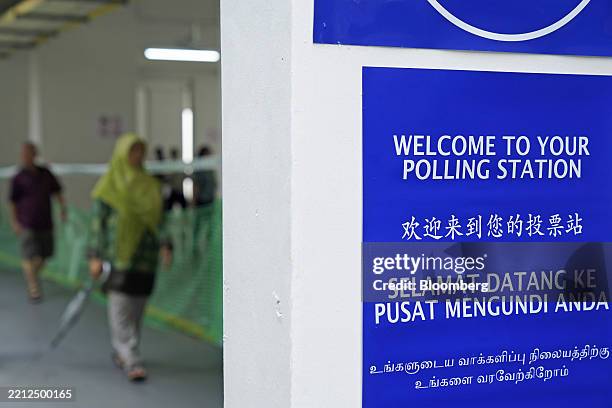 Welcome sign in different languages at a polling station inside a Housing & Development Board public housing estate in Singapore, on Saturday, May 3,...