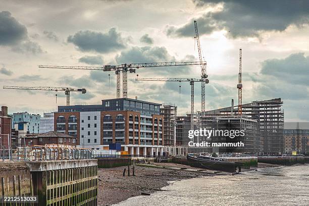 construction site with tower cranes and unfinished buildings - construction stock pictures, royalty-free photos & images