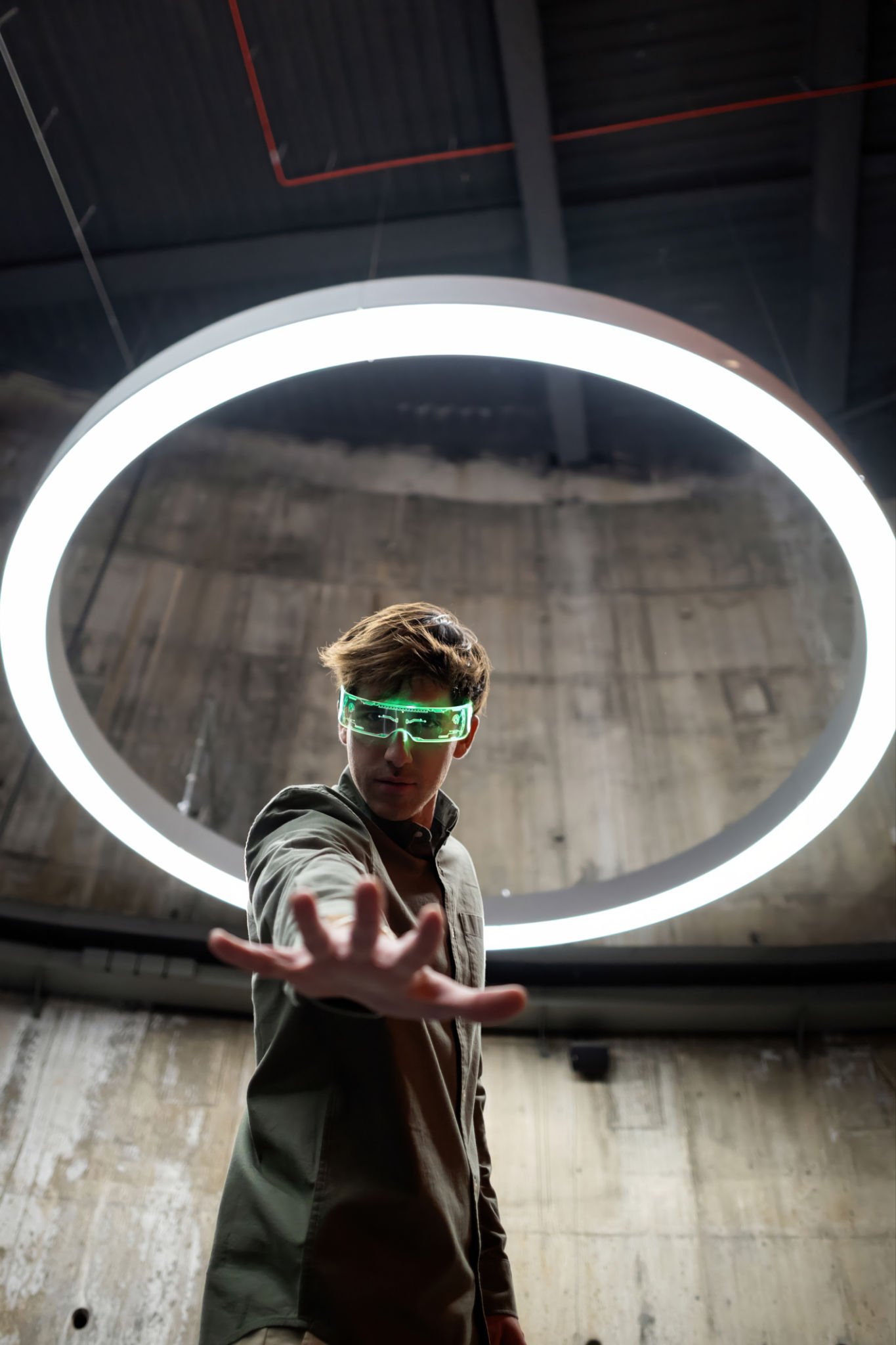 Software developer reaching out with futuristic glasses and neon light circle Software developer reaching out with futuristic glasses and neon light circle