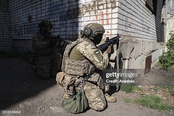 New infantry recruits aged 18-24 train in a mock assault on a building in Donetsk Oblast on May 03, 2025. Ukraine is offering one-year army contracts...