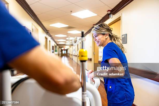 nurses pushing a hospital bed with a patient down the hallway - gurney point of view stock pictures, royalty-free photos & images