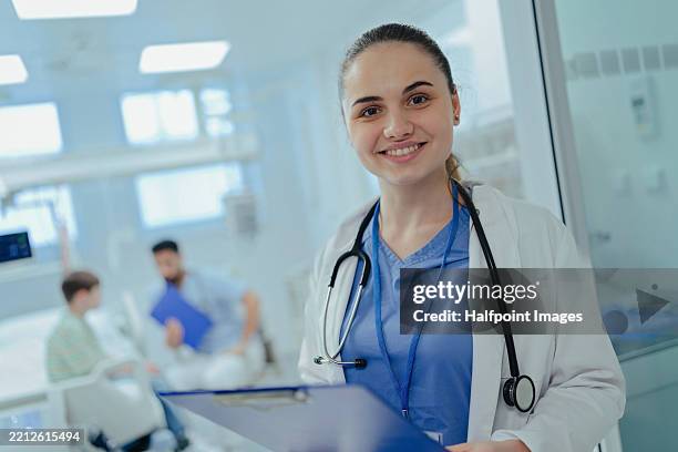 portrait of young female doctor in hospital. - medical school stock pictures, royalty-free photos & images