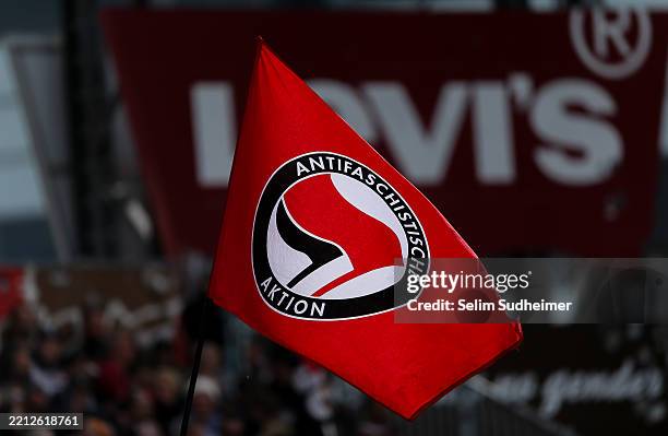 St. Pauli fans show their support with a "Antifaschistische Aktion" flag during the Bundesliga match between FC St. Pauli 1910 and VfB Stuttgart at...