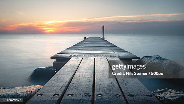 scenic view of sea against sky during sunset - ponton photos et images de collection