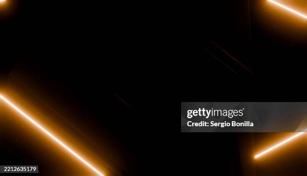 abstract glowing orange lines on a black background creating a futuristic design. 3d rendering - light trail black background stock illustrations