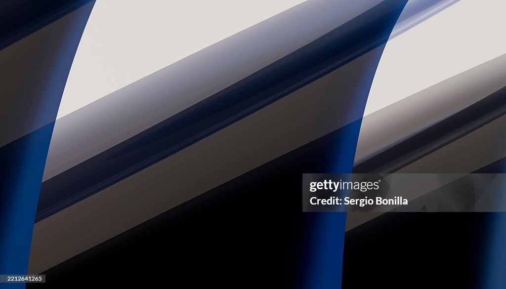 Abstract image of curved blue and black lines with light reflections creating a dynamic pattern. Blender 3D illustration