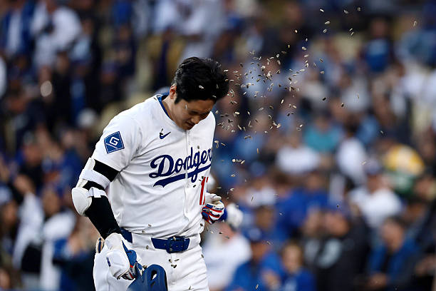 Shohei Ohtani of the Los Angeles Dodgers is doused with sunflower seeds after hitting a home run during the first inning against the Miami Marlins at...