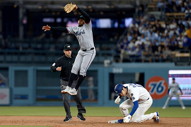Shohei Ohtani of the Los Angeles Dodgers steals second base against Otto Lopez of the Miami Marlins during the second inning at Dodger Stadium on...