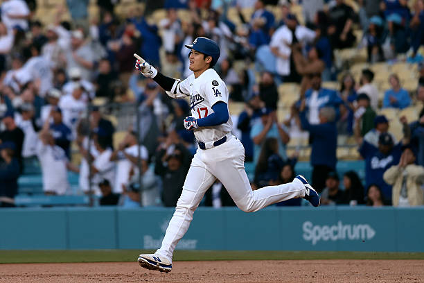 Shohei Ohtani of the Los Angeles Dodgers celebrates after hitting a home run during the first inning against the Miami Marlins at Dodger Stadium on...