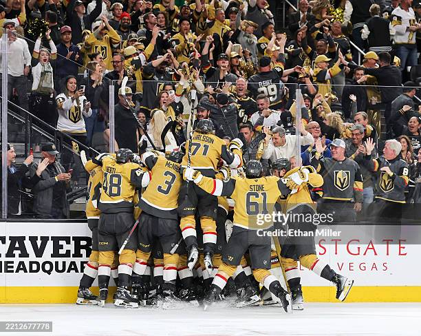 The Vegas Golden Knights celebrate after Brett Howden scored an overtime goal against the Minnesota Wild for a 3-2 victory in Game Five of the First...