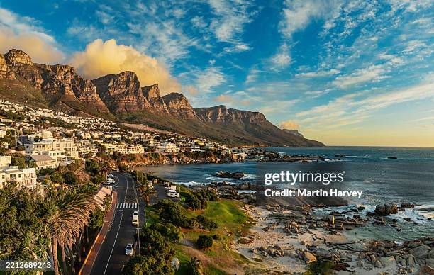 high view of the popular tourist destination cape town. camps bay with the twelve apostles mountain range in the background. cape town, south africa - camps bay stock pictures, royalty-free photos & images