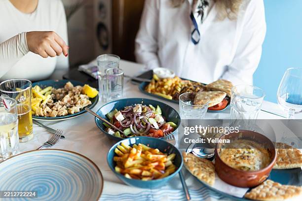 greek specialties served on a restaurant table - griechische küche stock-fotos und bilder