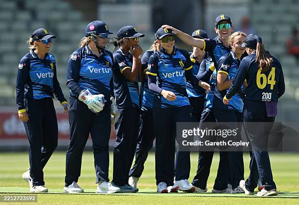Issy Wong of Warwickshire is congratulated by teammates after catching out Orla Prendergast of The Blaze during the Metro Bank One Day Cup match...