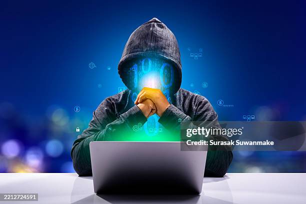 faceless hackers and malware hackers use laptops with dangerous digital code on binary code background. - hack saw stock pictures, royalty-free photos & images