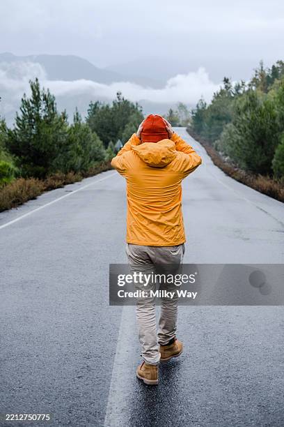 solitary adventure on misty mountain road - autumn exploration and outdoor journey - avoidance stock pictures, royalty-free photos & images