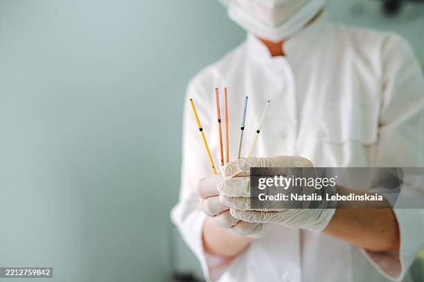 cryopreservation technology embryologist demonstrates high-security straw system - human egg stock pictures, royalty-free photos & images