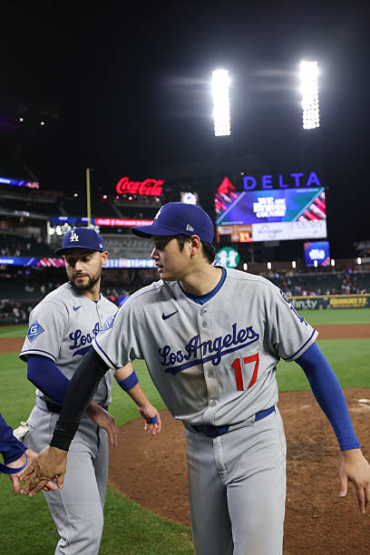 Shohei Ohtani of the Los Angeles Dodgers celebrates a win after the game between the Los Angeles Dodgers and the Atlanta Braves at Truist Park on...