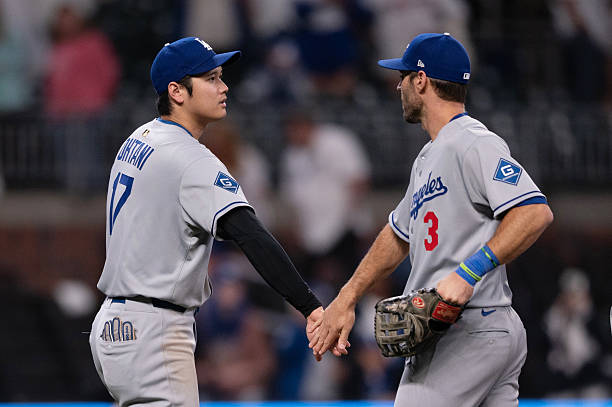 Shohei Ohtani of the Los Angeles Dodgers and Chris Taylor celebrate a win after the game between the Los Angeles Dodgers and the Atlanta Braves at...