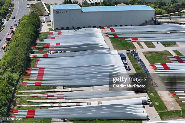 An aerial view shows wind turbine blades piled up in a wind turbine blade production base in Yancheng City, Jiangsu Province, China, on May 4, 2025.