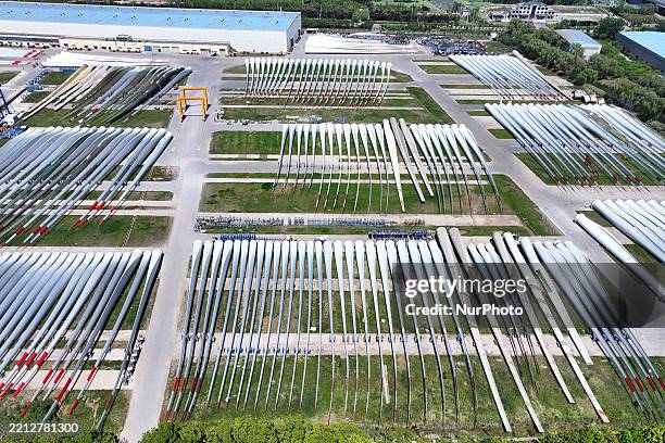 An aerial view shows wind turbine blades piled up in a wind turbine blade production base in Yancheng City, Jiangsu Province, China, on May 4, 2025.