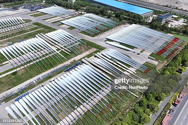 An aerial view shows wind turbine blades piled up in a wind turbine blade production base in Yancheng City, Jiangsu Province, China, on May 4, 2025.