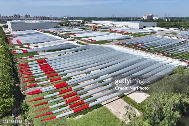 An aerial view shows wind turbine blades piled up in a wind turbine blade production base in Yancheng City, Jiangsu Province, China, on May 4, 2025.