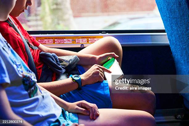 teenager using smartphone while traveling on bus - location tracking stock pictures, royalty-free photos & images