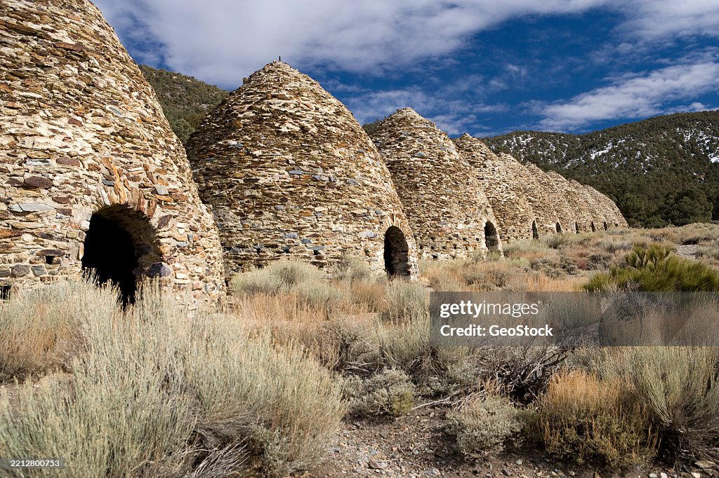 Beehive stone kilns in a desert landscape