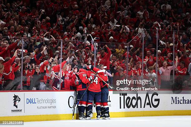 Brandon Duhaime of the Washington Capitals celebrates with teammates after scoring an empty net goal against the Montreal Canadiens during the third...