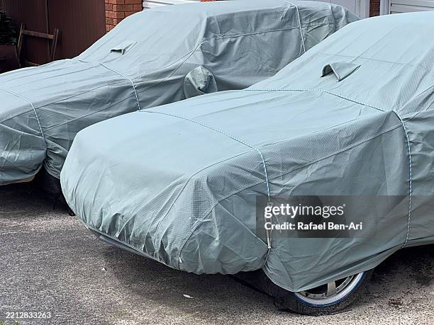 two covered collector vehicles - car covered with cloth stock pictures, royalty-free photos & images