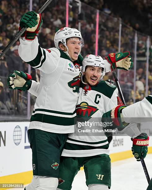 Matt Boldy and Jared Spurgeon of the Minnesota Wild celebrate after Boldy scored a goal against the Vegas Golden Knights in the third period of Game...