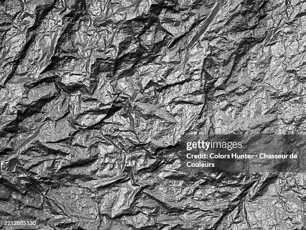 close-up of a crumpled gray plastic tarp. rough texture. black and white. sunlight.
london, england, united kingdom.
full frame 4:3 - tarpaulin design stock pictures, royalty-free photos & images