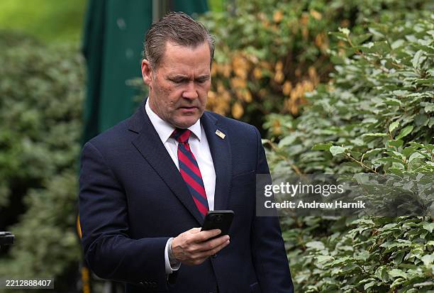 National Security Advisor Michael Waltz looks at his phone as he prepares for a TV interview at the White House on May 01, 2025 in Washington, DC....