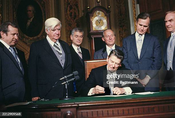 President Ronald Reagan signing the federal employee hiring freeze memorandum and the cabinet member nominations in the US Capitol's President's...
