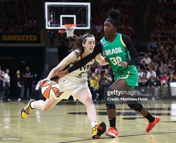 Guard Caitlin Clark of the Indiana Fever goes to the basket during the first half against guard Catarina Helena Ferreira de Oliveira of the Brazil...