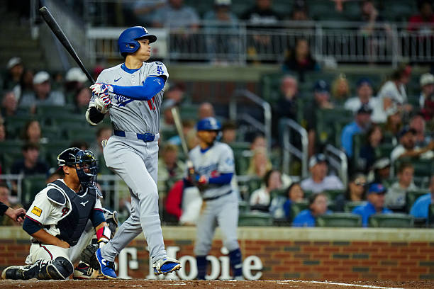 Shohei Ohtani of the Los Angeles Dodgers hits a double in the seventh inning during the game between the Los Angeles Dodgers and the Atlanta Braves...