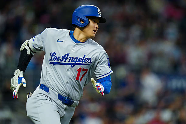Shohei Ohtani of the Los Angeles Dodgers rounds the bases after hitting a double in the seventh inning during the game between the Los Angeles...
