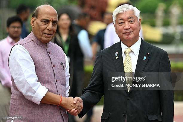 Japan's Defence Minister Gen Nakatani shakes hands with his Indian counterpart Rajnath Singh during his ceremonial reception in New Delhi on May 5,...